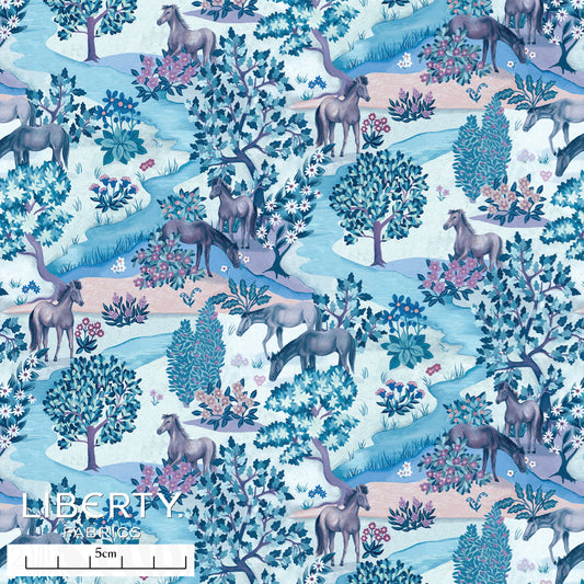 Liberty print with horses trees and flowers in a blue colourway
