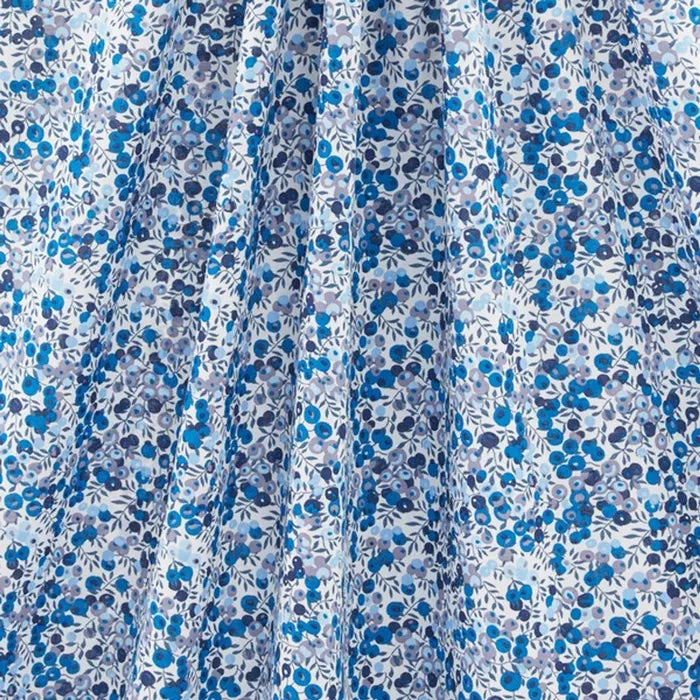 liberty print with blue berries and leaves on white background zoomed out photo